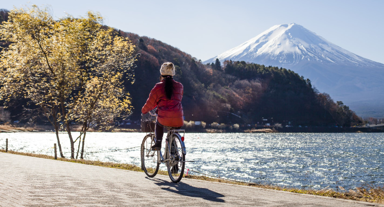 Woman biking by a lake