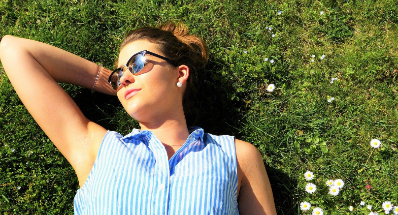Young woman laying in field